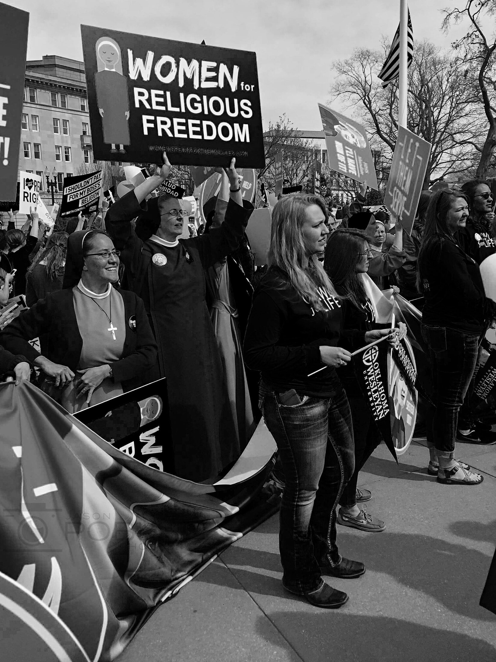 A marcher carries a sign during a religious procession.