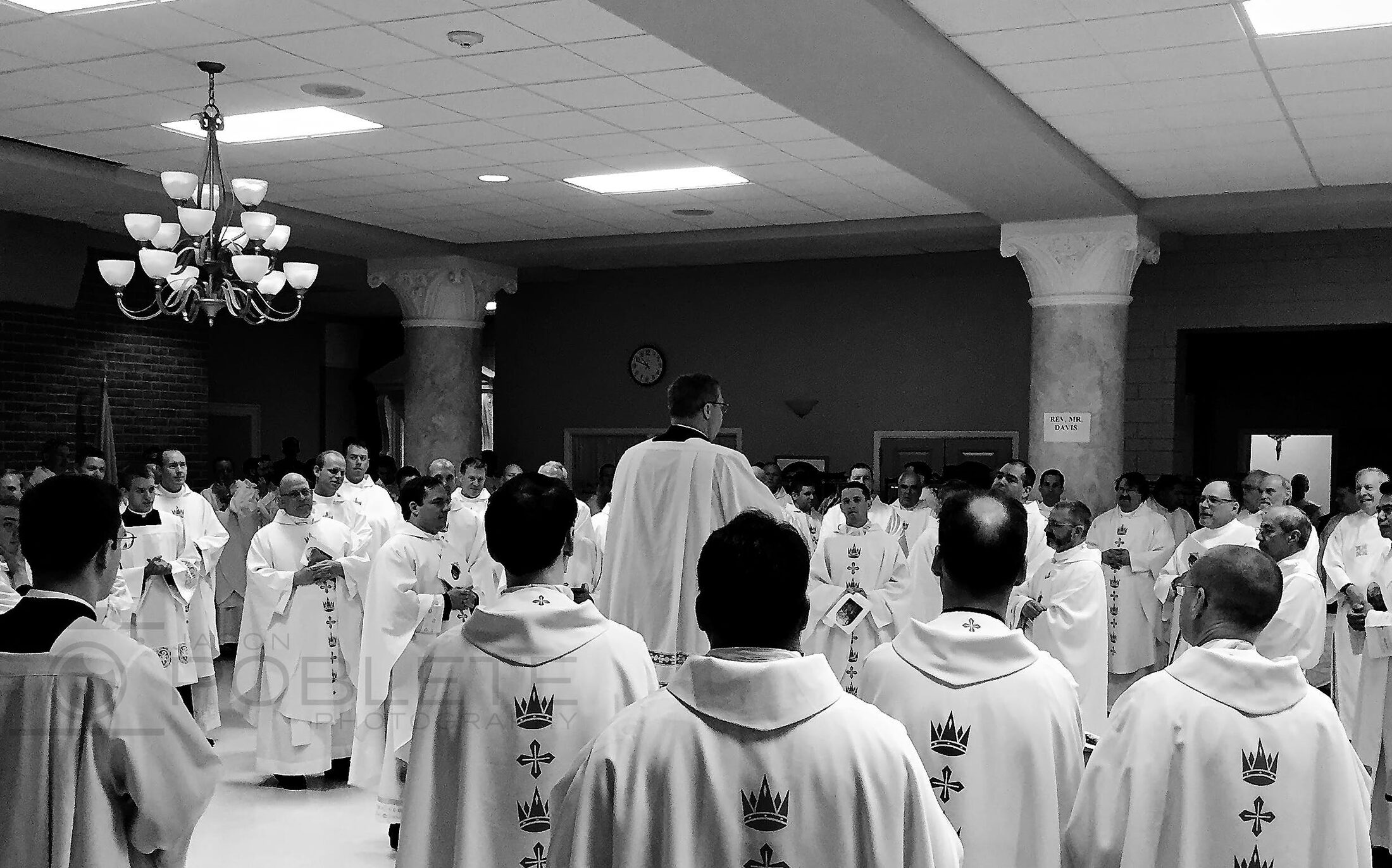 Rows of clergy face an altar during a church service.
