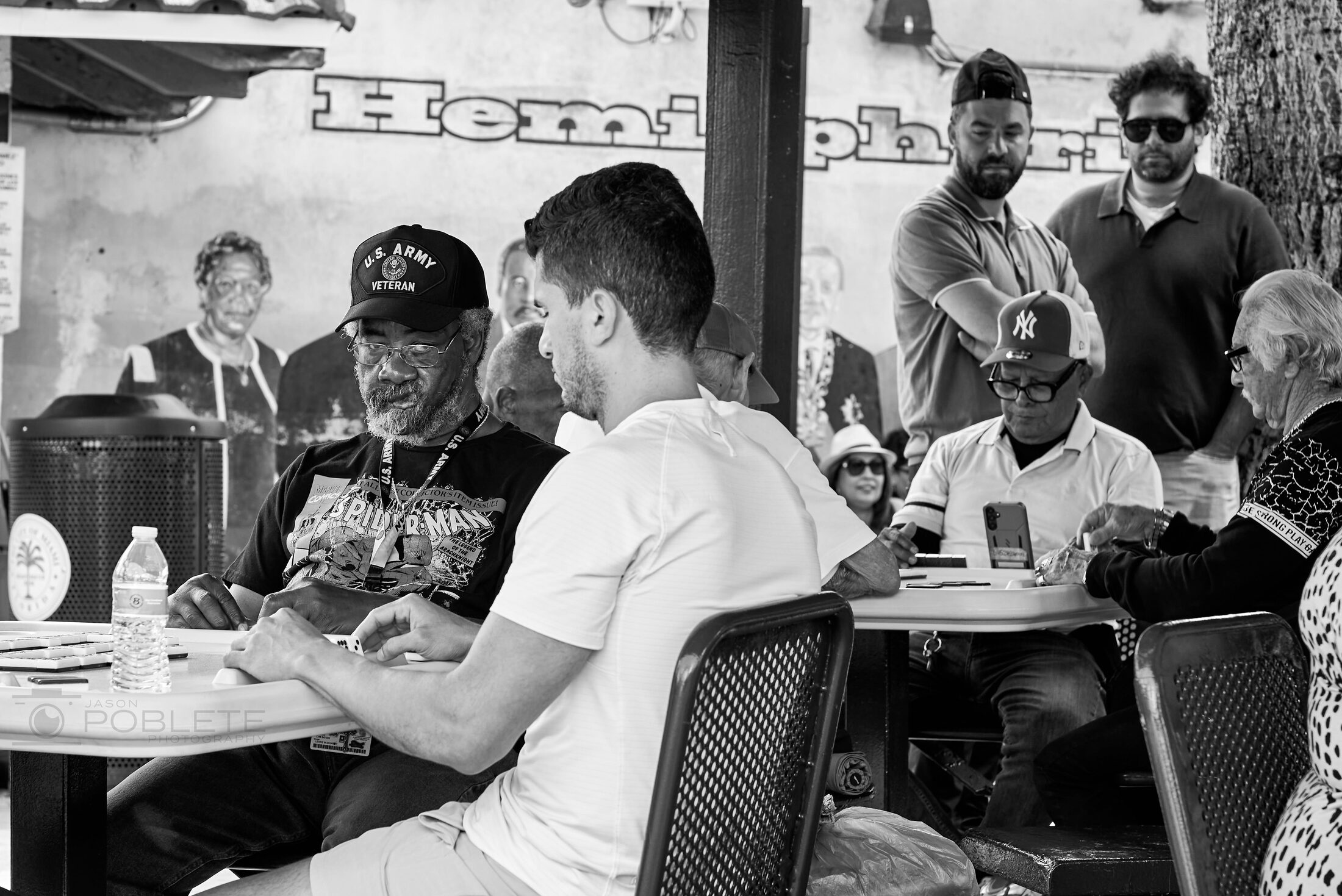 Diners gather closely around a table in a busy restaurant.
