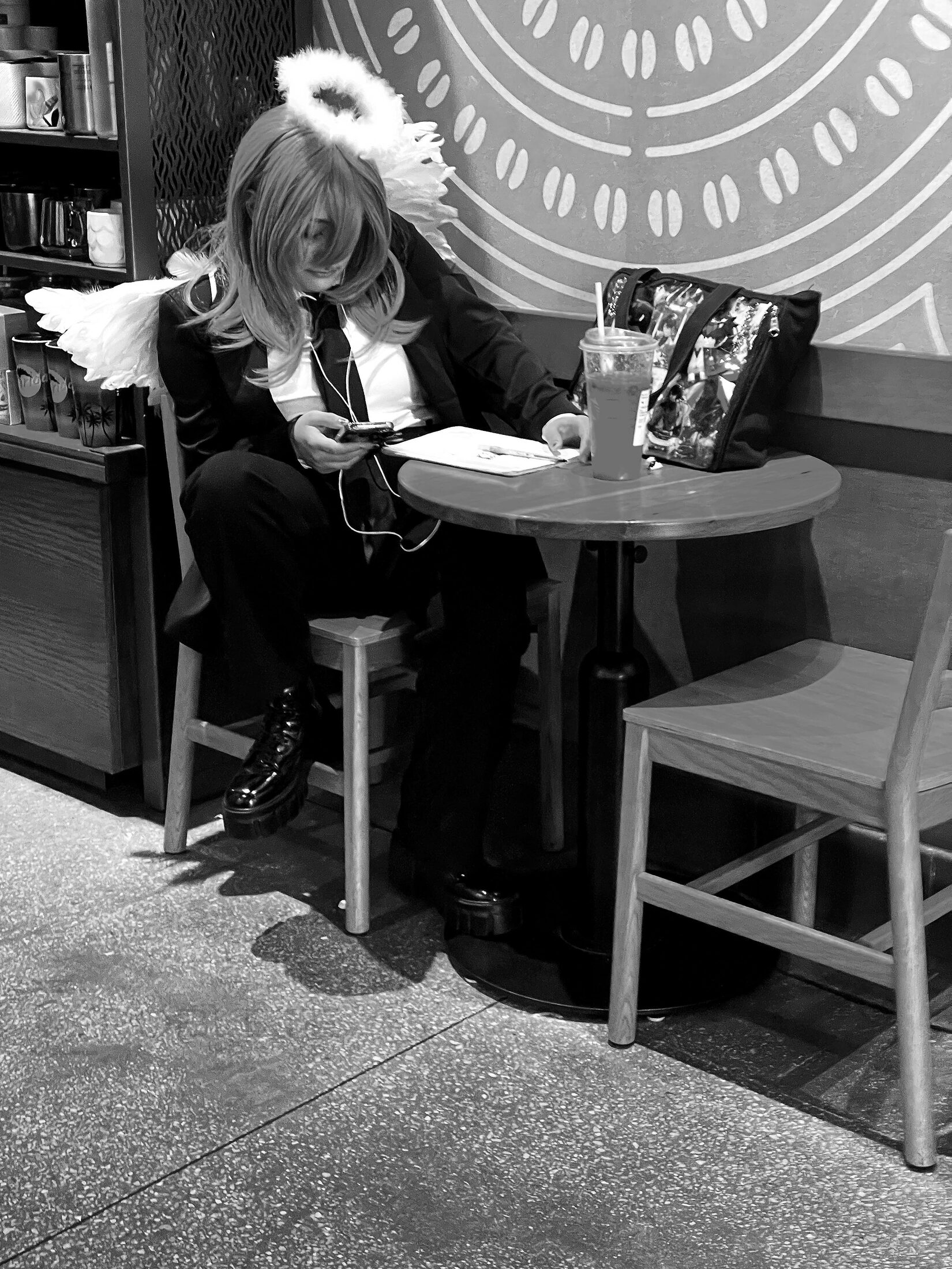 A man plays an upright piano in a café.